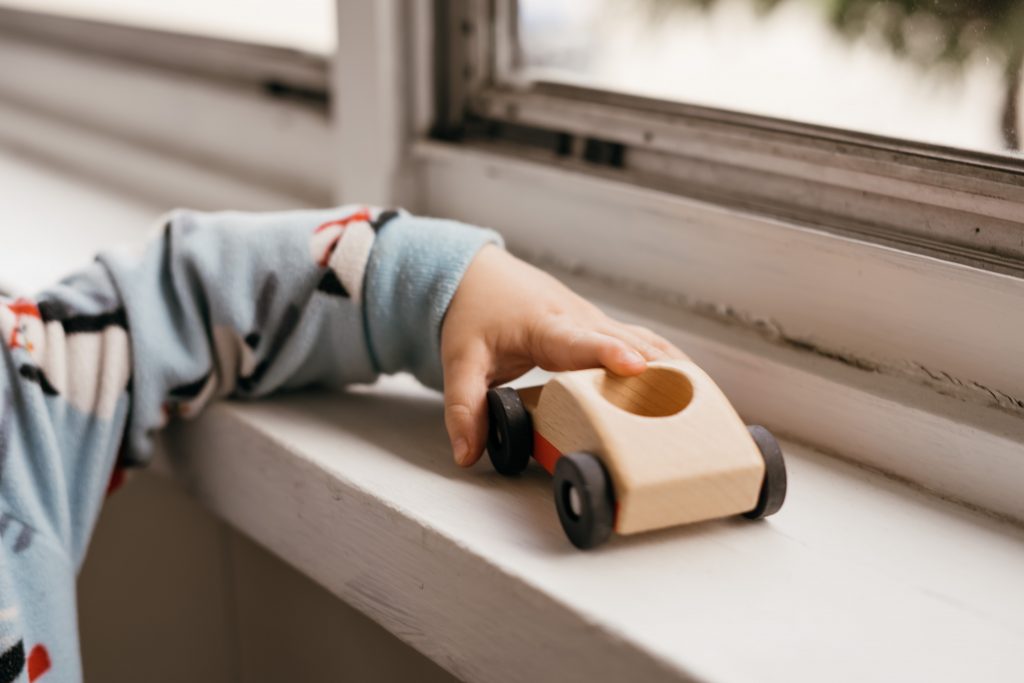 Toddler with a toy car