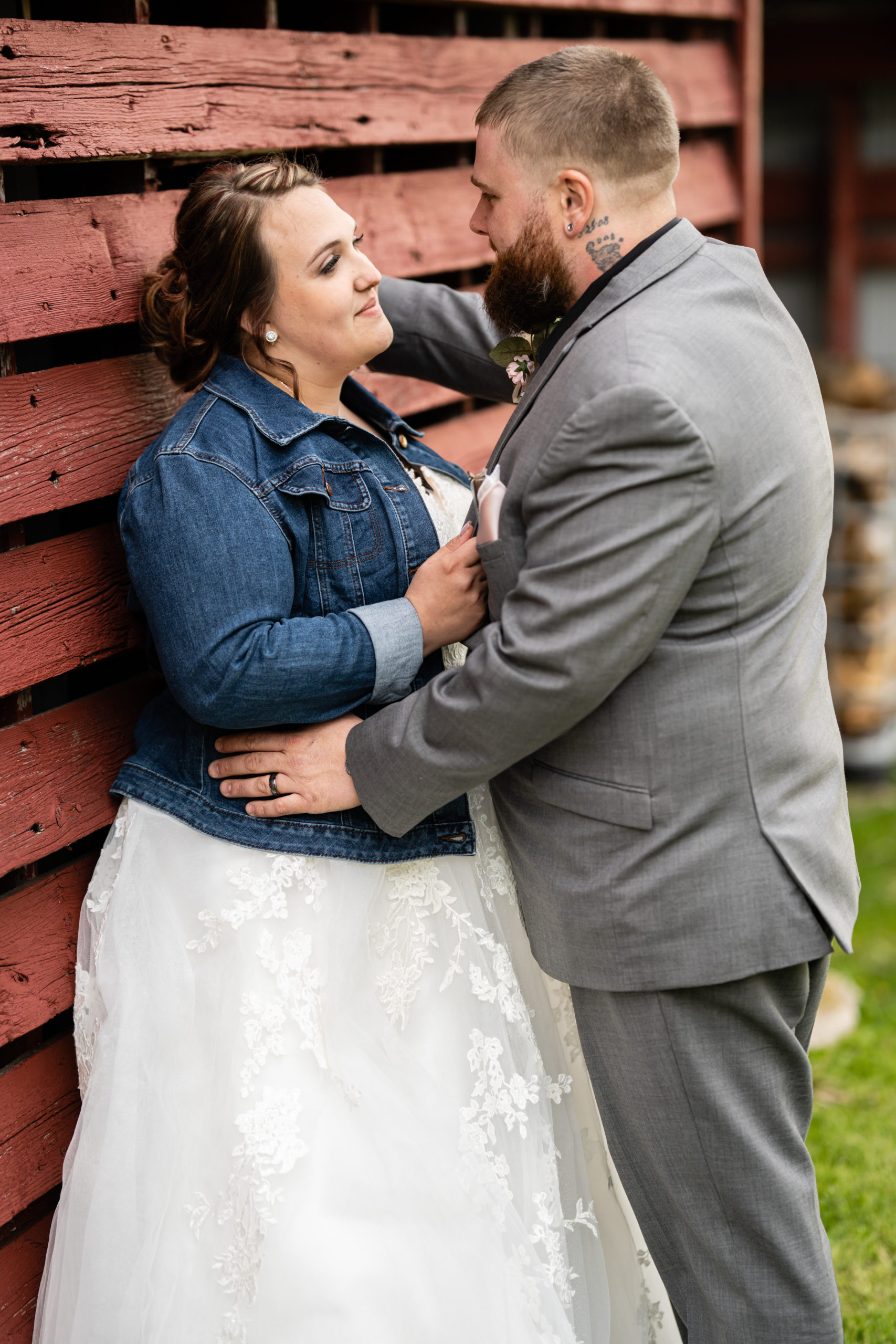 Bride and groom at a barn wedding being photographed by Lisa Wiker Photography Oshkosh Wedding Photographer
