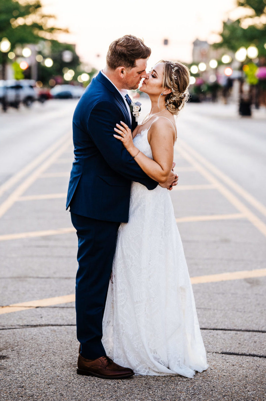 bride and groom standing in a road at golden hour