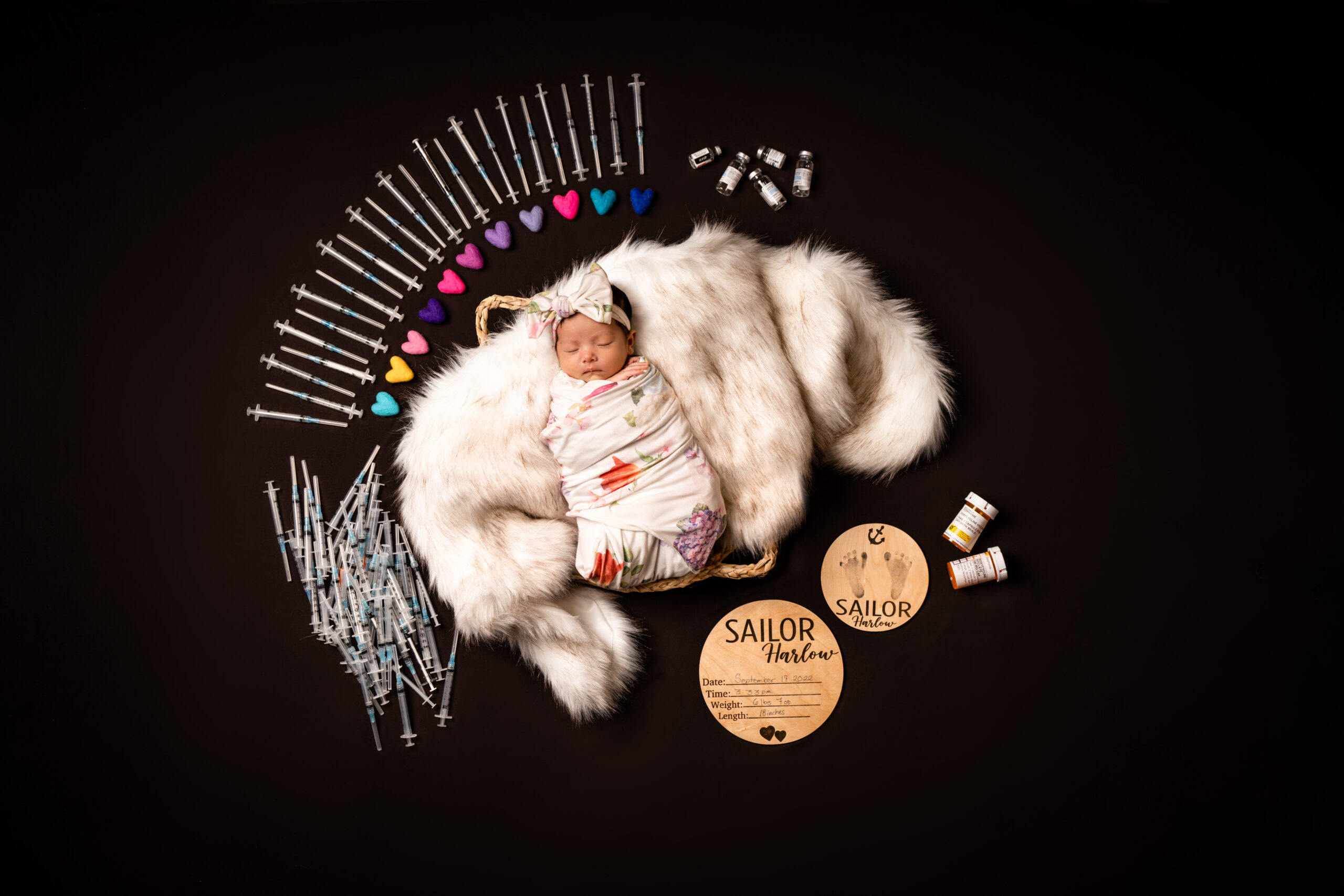 newborn laying on fur in a basket showing IVF treatments