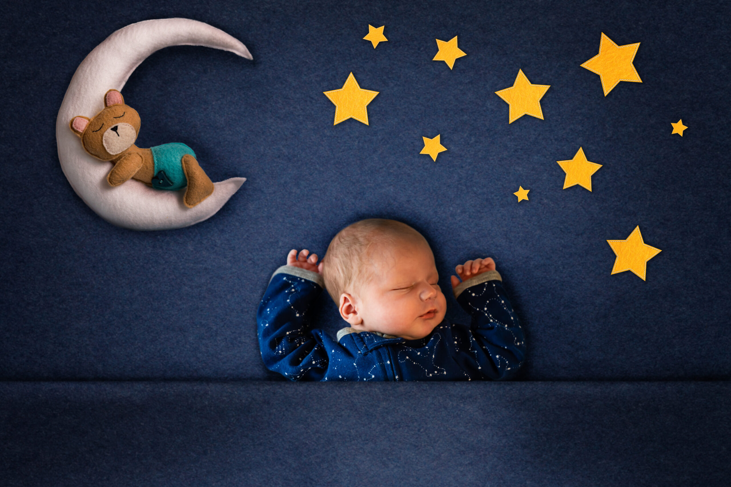 Newborn photograph with little bear on a moon and stars in felt