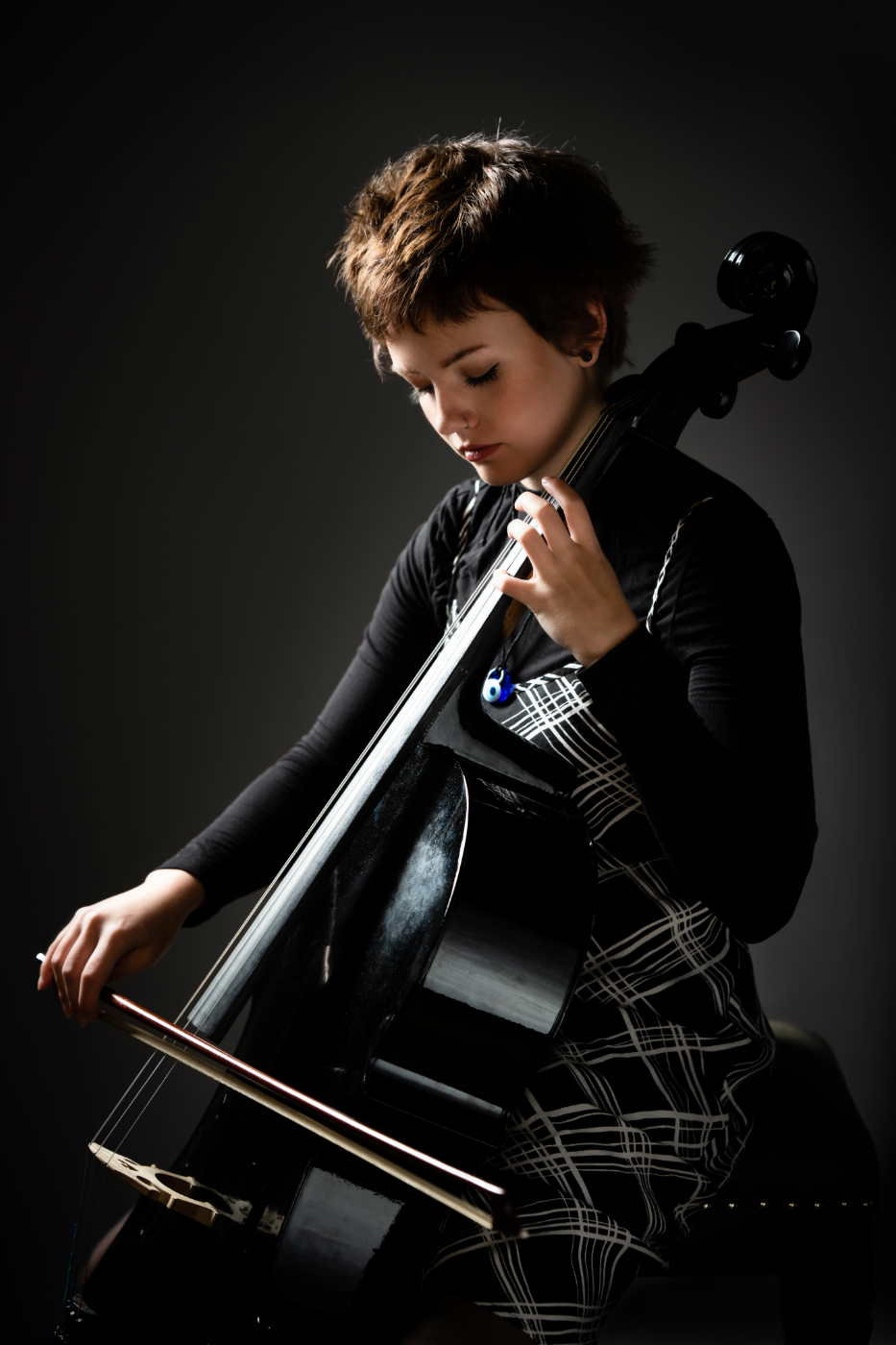 High school senior girl playing cello in Oshkosh photography studio